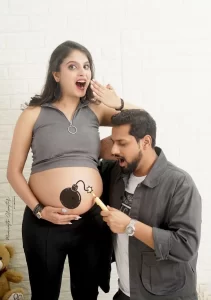 Maternity Photoshoot of a couple with a interesting pose by Moments Creator by Anushka in Dwarka Delhi Gurgaon