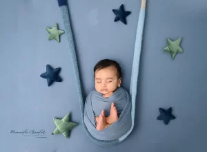 Newborn Baby photoshoot posing on Swing