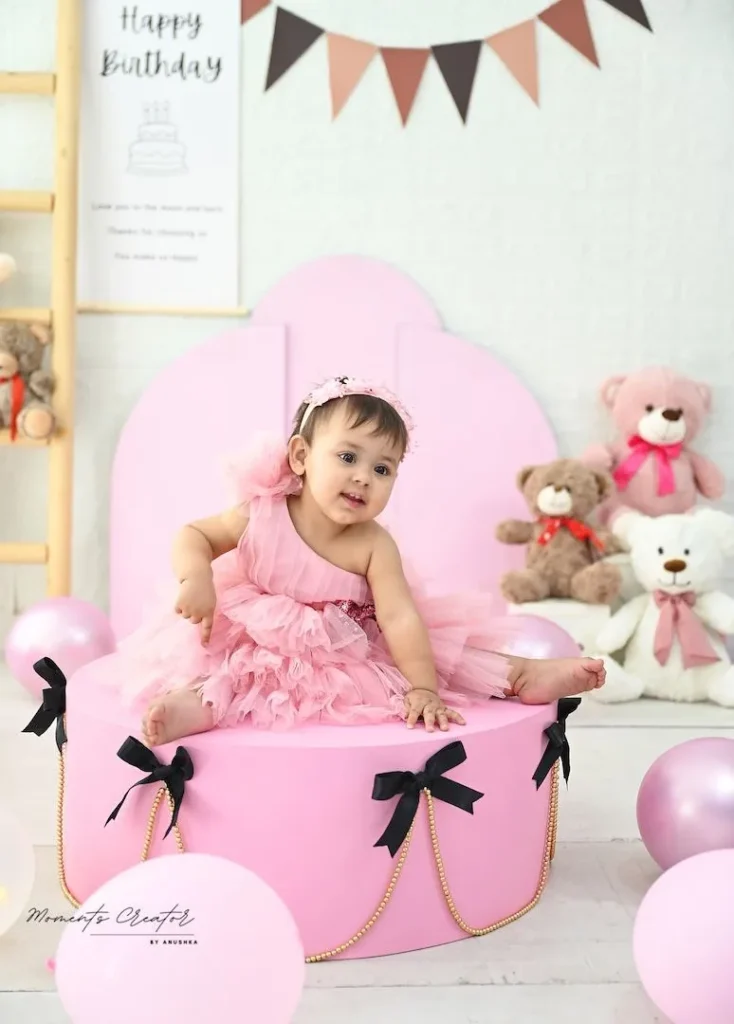 first-birthday-photography-delhi-ncr-pink-ruffle-dress-pink-pedestal-black-bows-teddies-54