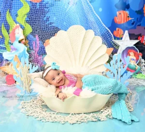 best infant photographer delhi ncr baby girl mermaid theme seashell smiling