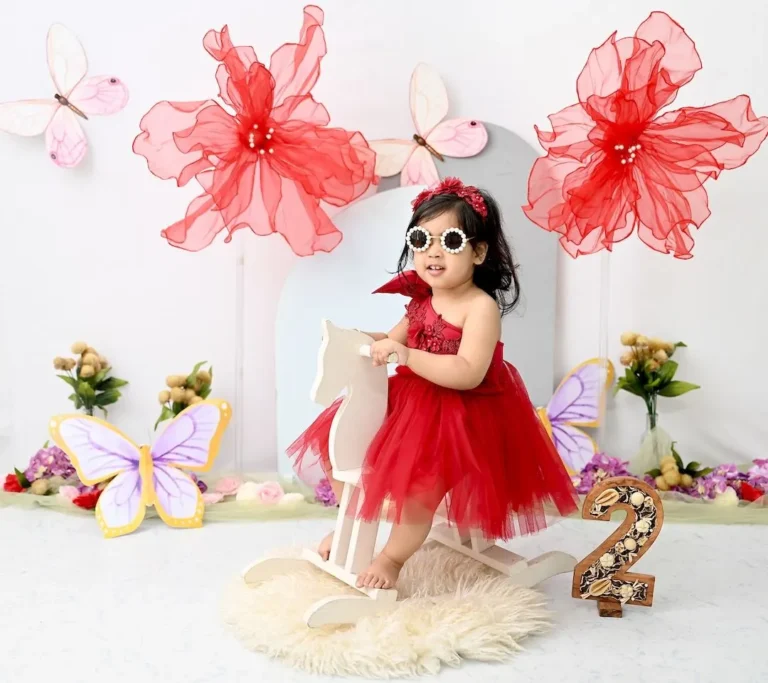 professional kids photography studio delhi toddler girl rocking horse sunglasses red dress
